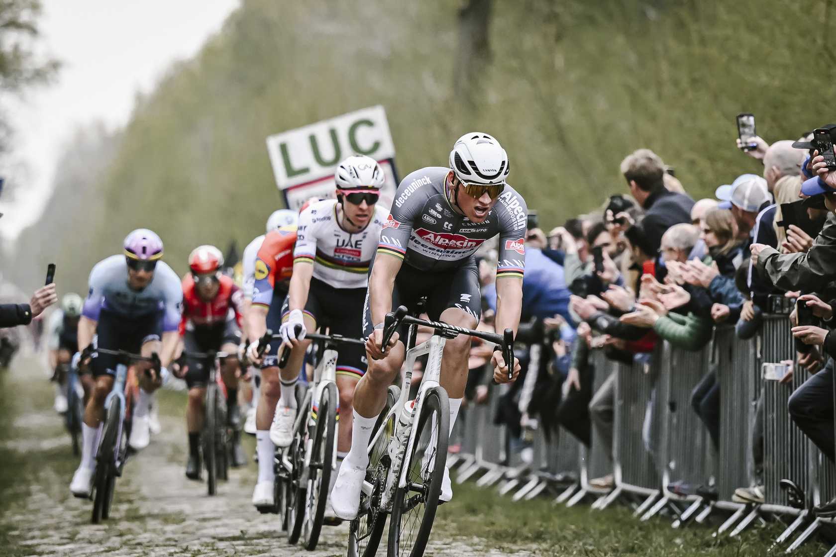 athieu van der Poel leading Tadej Pogacar and Mads Pedersen through Trouee d'Arenberg at Paris-Roubaix 2025